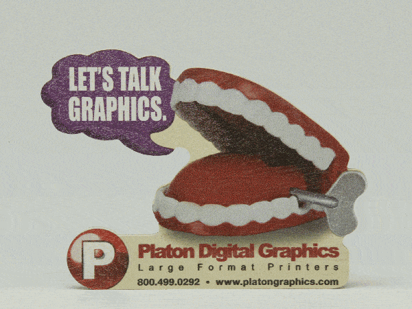 Wind up teeth holding Platon Graphics sign Custom graphics can draw attention to your business like these wind up teeth here.
