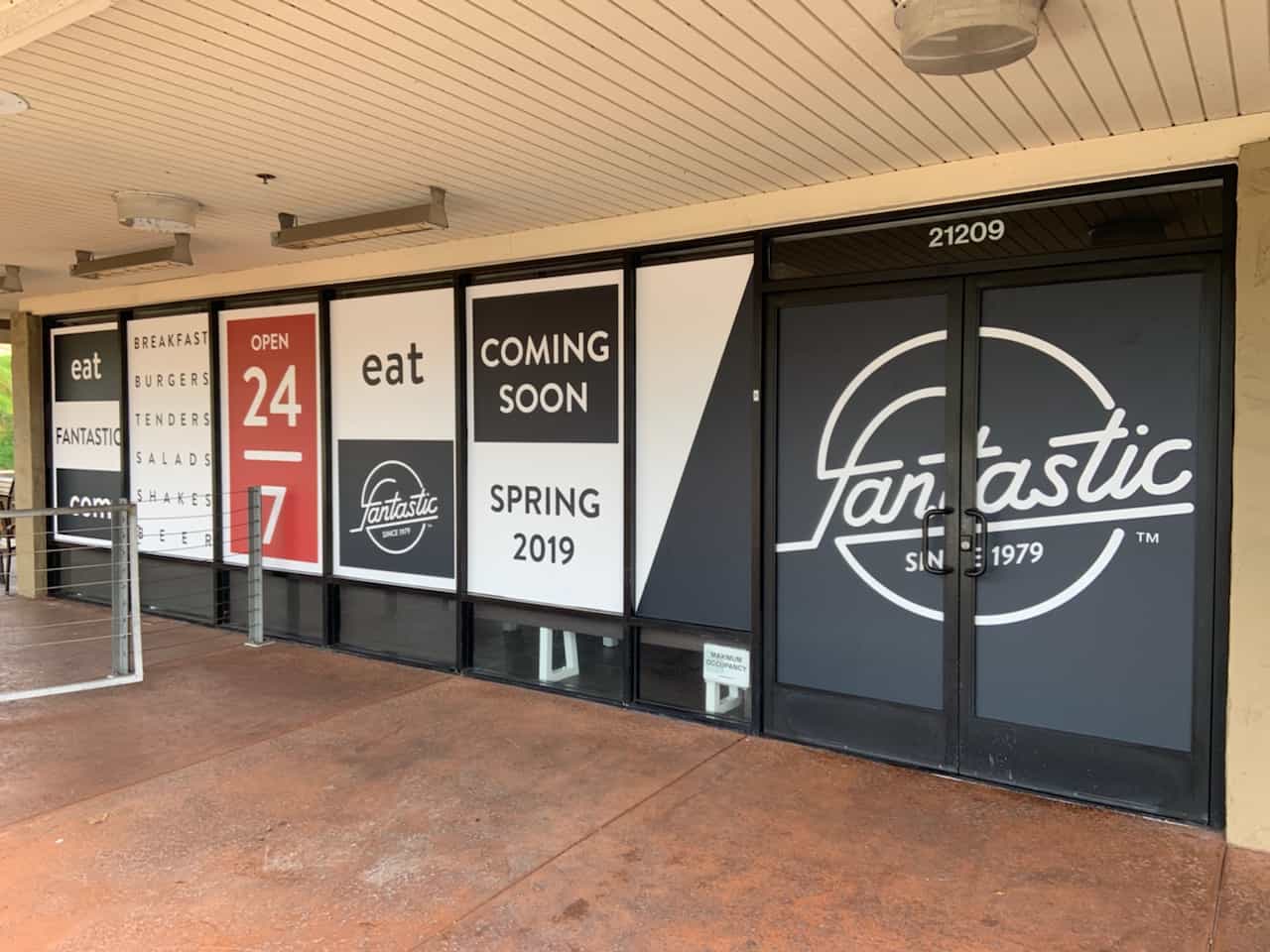 a store front with a lot of signs on it.
