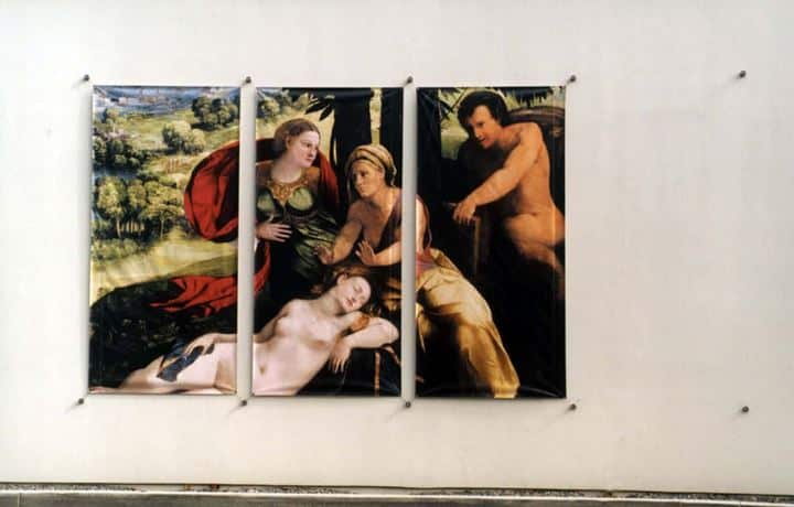 GETTYCUR three paintings on a wall of a woman and two men.
