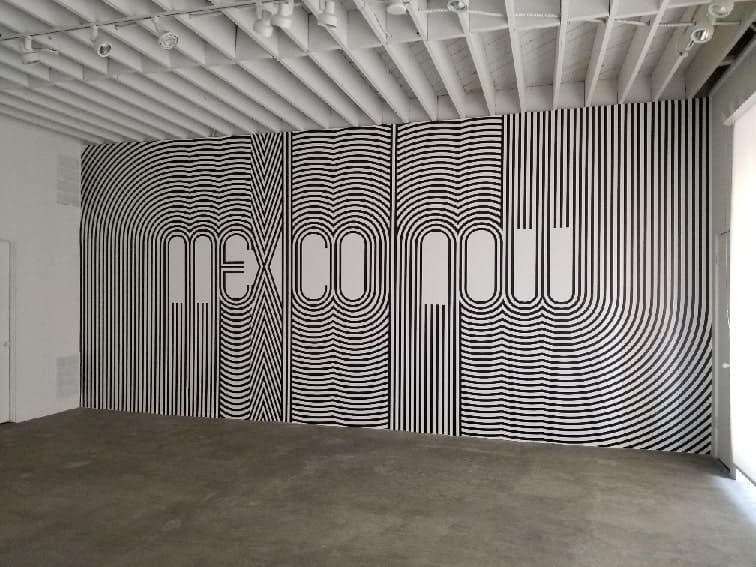 a large black and white painting on a wall.
