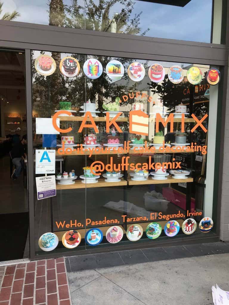 a store front window with a variety of items in the window.