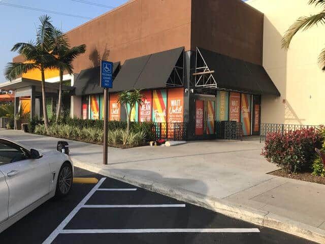 What technology does decal printing use for this store with a car parked in a parking lot in front of it??
