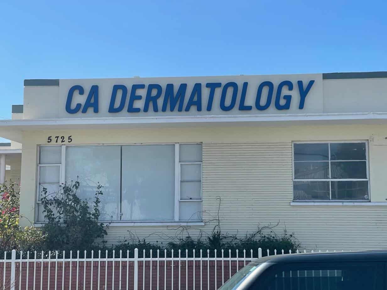 CA Dermatology Halo lit Channel letters on raceway- dayview closeup a car parked in front of a building with a sign that reads ca dermat.