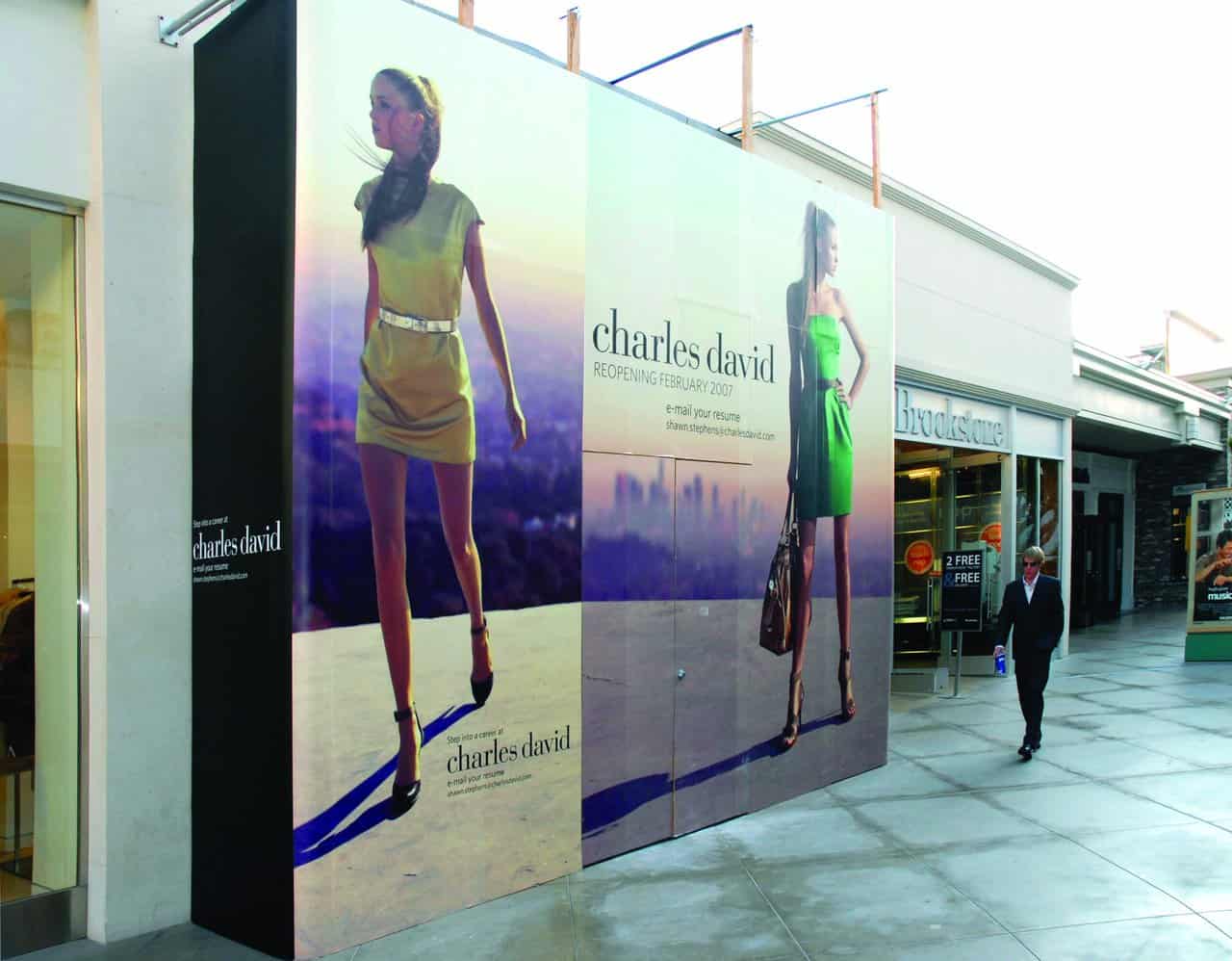 CharlesDavidOutside a man walking down a sidewalk next to a building.