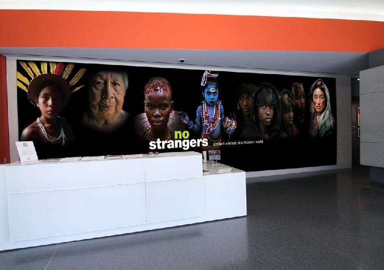 No Strangers Wall there is a wall with pictures of people on it.