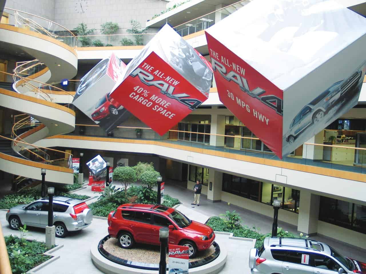 Toyota 2 a building with a bunch of cars parked inside of it.