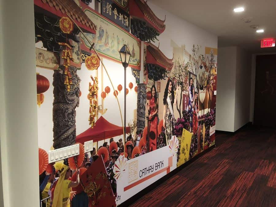 a hallway with a office space murals for corporations featuring  ladies in asian tradicional customs in a parated a hallway with a office space murals for corporations featuring ladies in asian tradicional customs in a parated