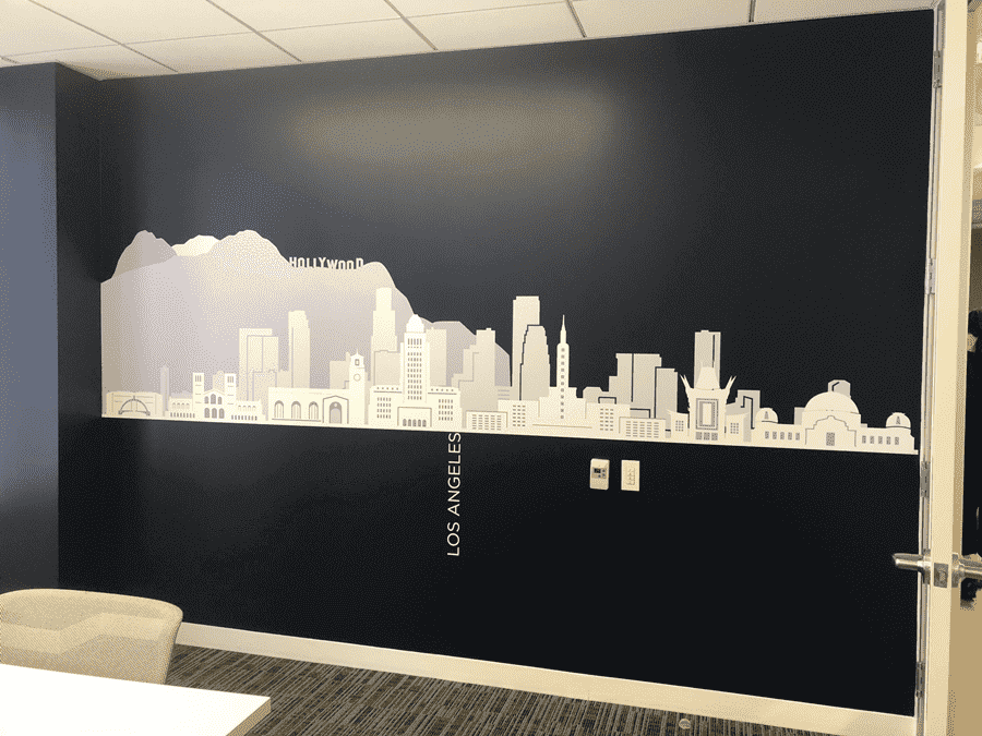 A meeting room with a office wall mural  featuring a black and white city skyline silhouette of Los Angeles city A meeting room with a office wall mural featuring a black and white city skyline silhouette of Los Angeles city