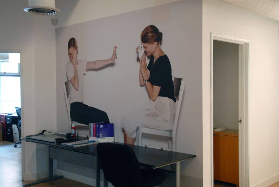 DSC_0923 a wall with a picture of two women on it.