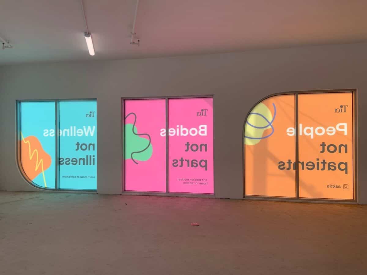 a room with three doors that have different colored signs on them.