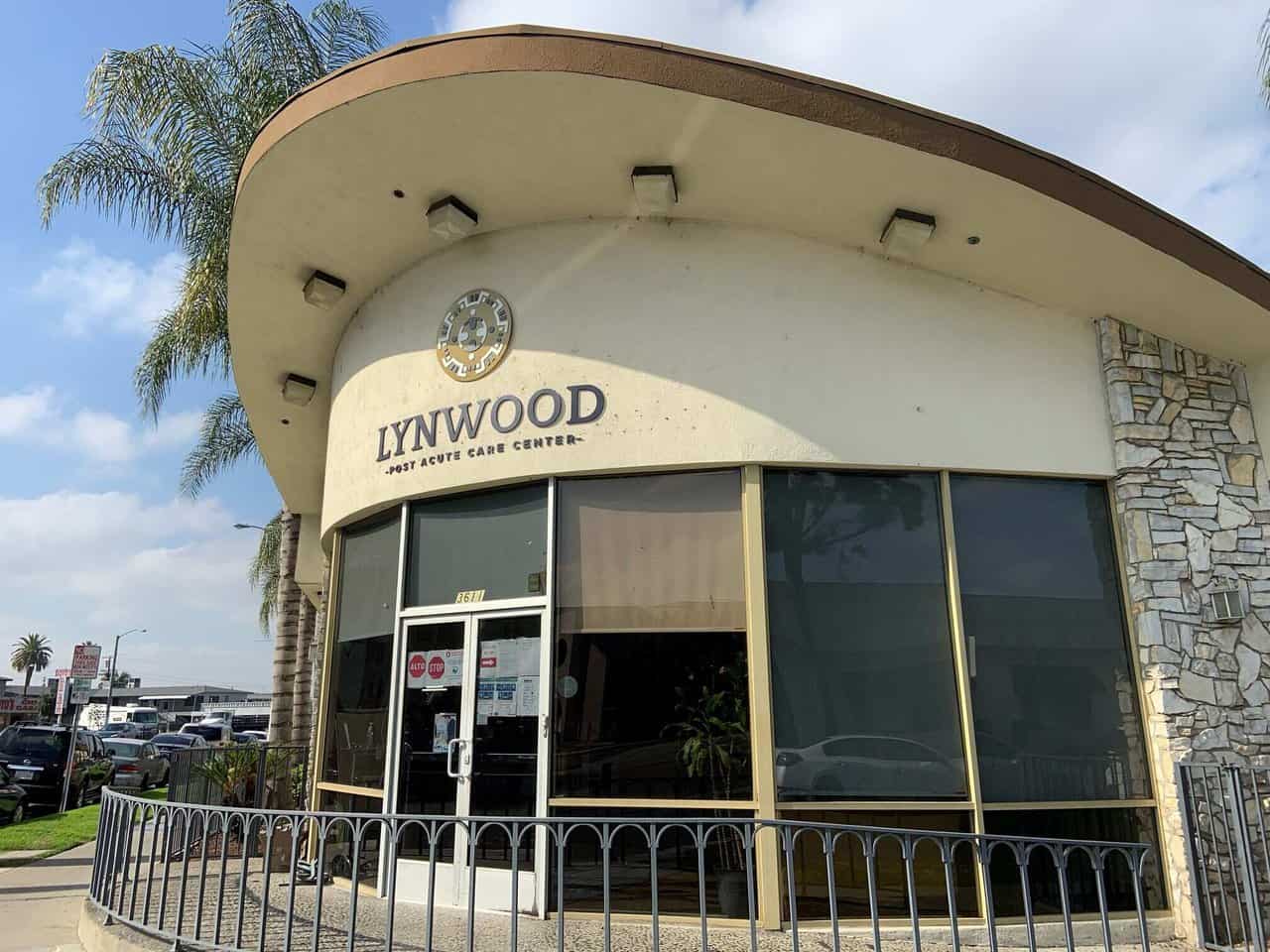 Lynwood sign the front of a building with a fence around it.