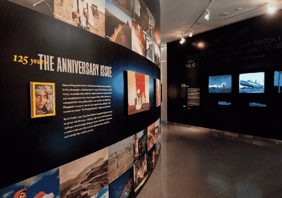National Geographic Wall a museum exhibit with a large number of pictures on the wall.