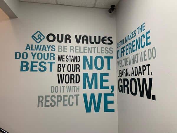 Values a wall with a quote painted on it.