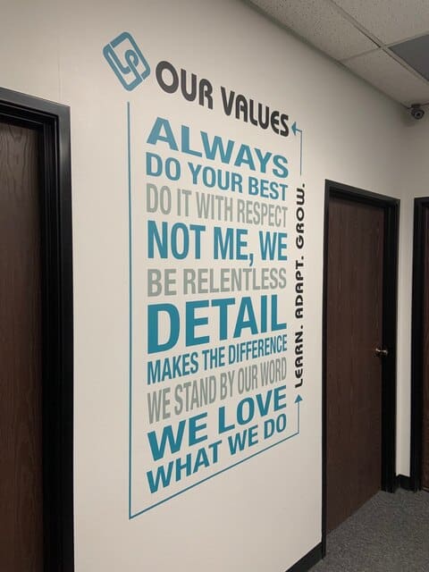 values2 a wall with a quote on it in an office.