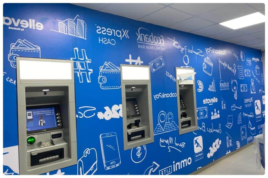 a blue wall with a bunch of atm machines on it.