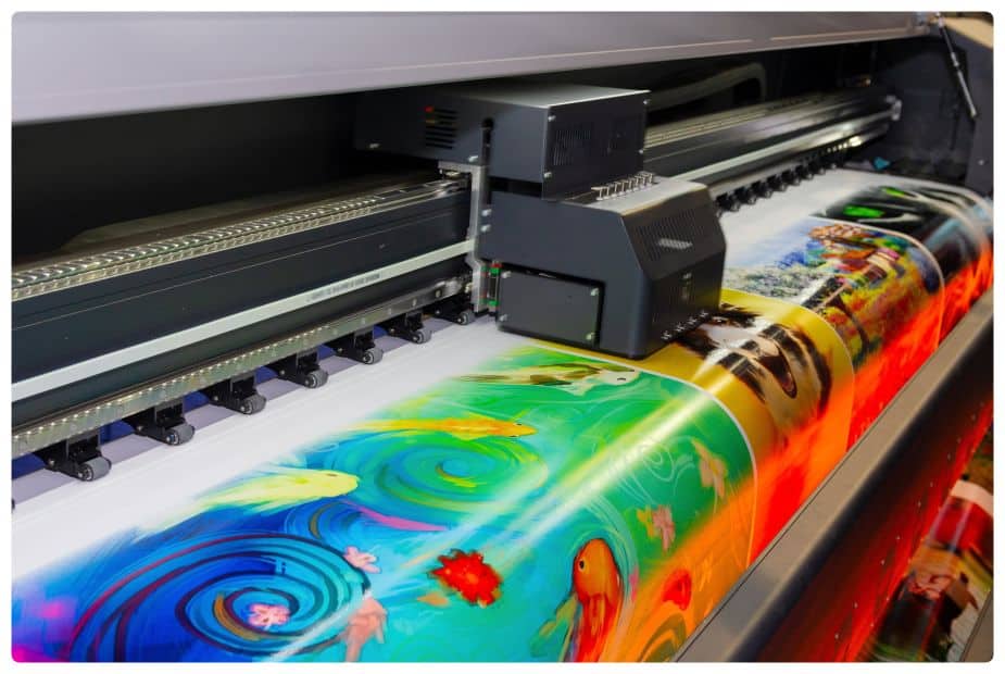 a large printer is printing a picture on a large sheet of paper.