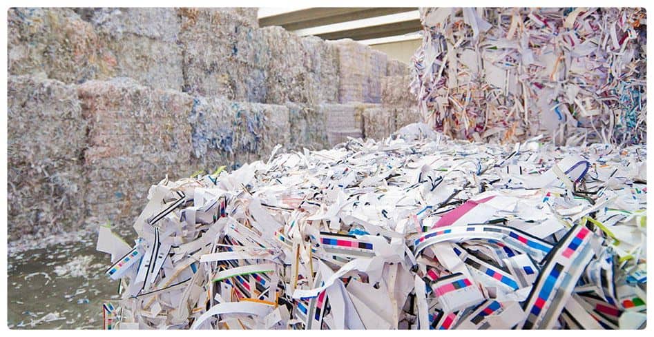 a large amount of papers are stacked on top of each other.