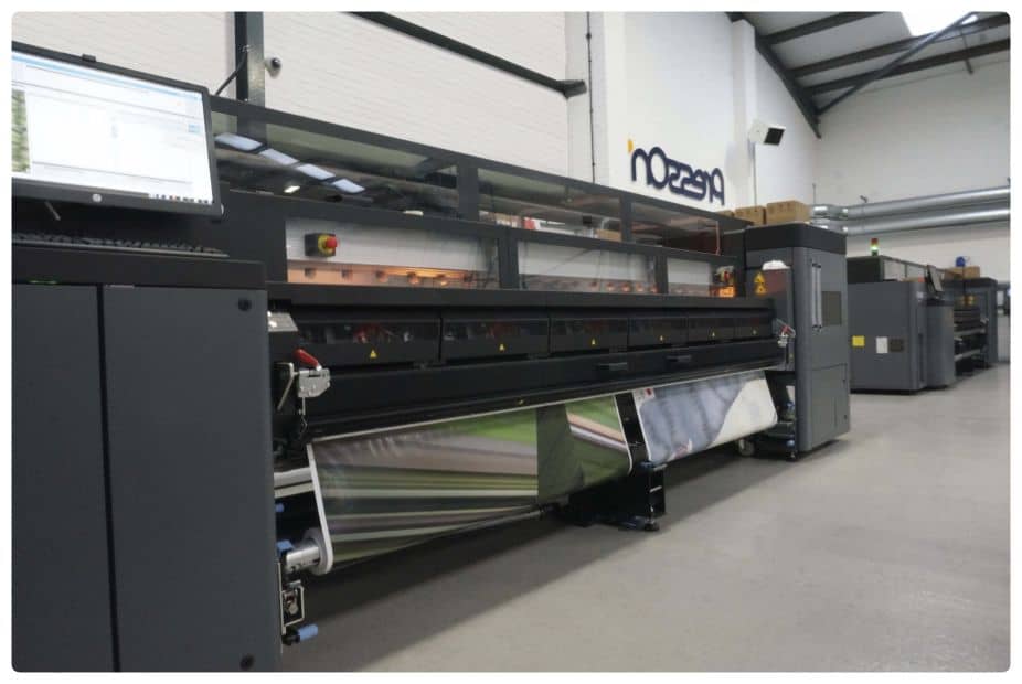 a large printing machine in a large warehouse.