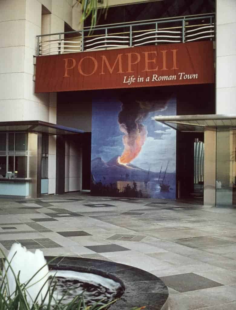 A building with a fountain and a sign that says pompeii life in a dominion town. A building with a fountain and a sign that says pompeii life in a dominion town.