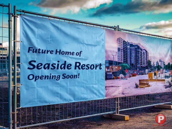 A construction site is fenced off with a con-ban-test that reads 